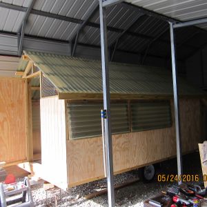 Front door and window covering with polycarbonate awnings.